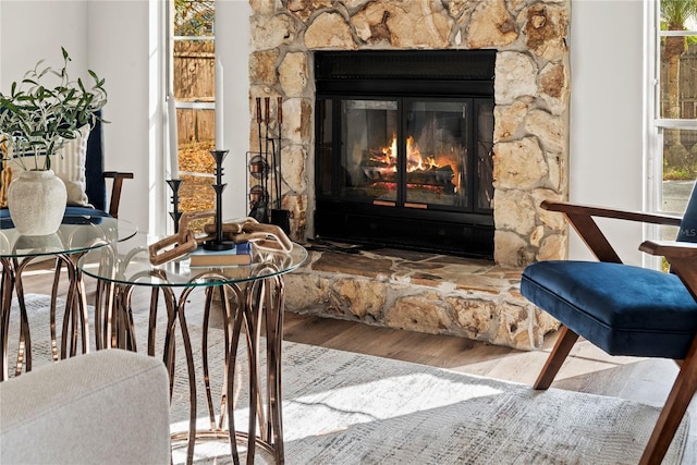 living area with a fireplace and wood finished floors