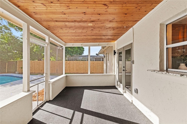 unfurnished sunroom featuring wooden ceiling