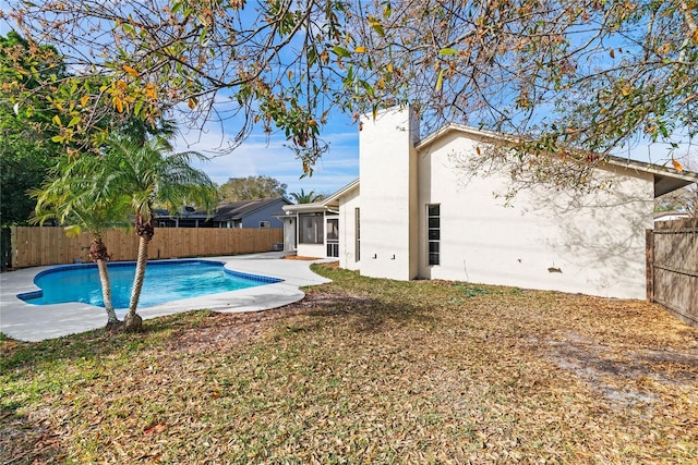 view of pool with a sunroom, a fenced backyard, and a fenced in pool