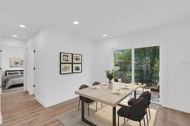 dining room featuring light wood-type flooring, baseboards, and recessed lighting