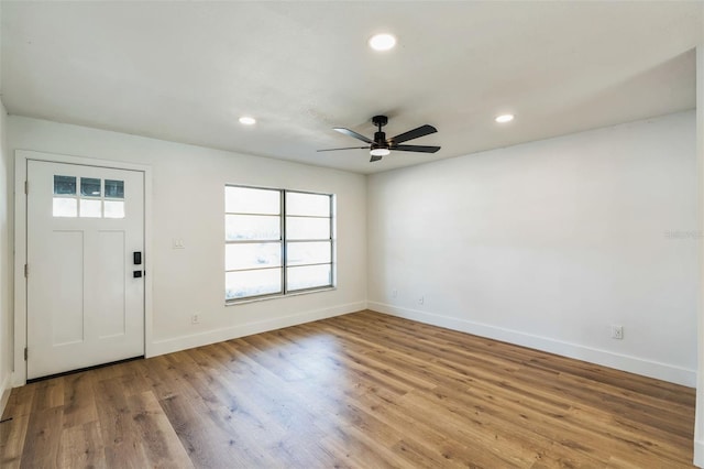 foyer featuring baseboards, wood finished floors, a ceiling fan, and recessed lighting