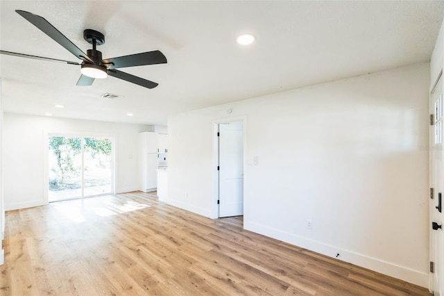 spare room with light wood-type flooring, visible vents, baseboards, and recessed lighting