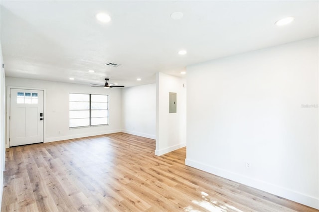 interior space with light wood-style floors, recessed lighting, visible vents, and electric panel