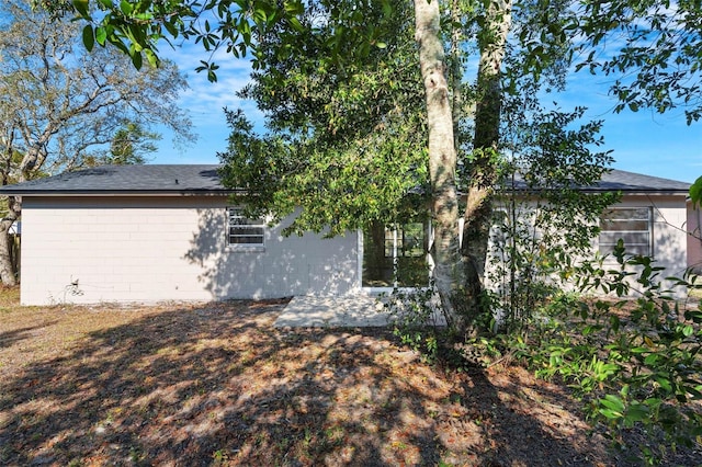 view of side of home with concrete block siding