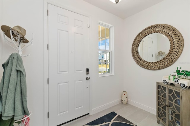 foyer entrance featuring baseboards and light tile patterned flooring