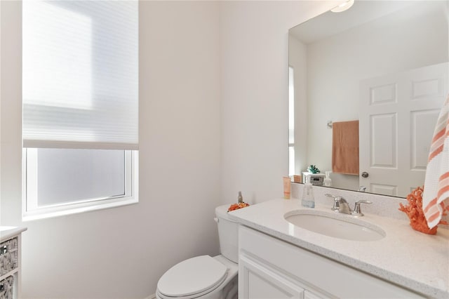 bathroom with toilet and vanity