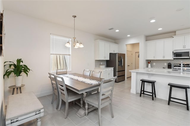 dining area featuring an inviting chandelier, baseboards, visible vents, and recessed lighting