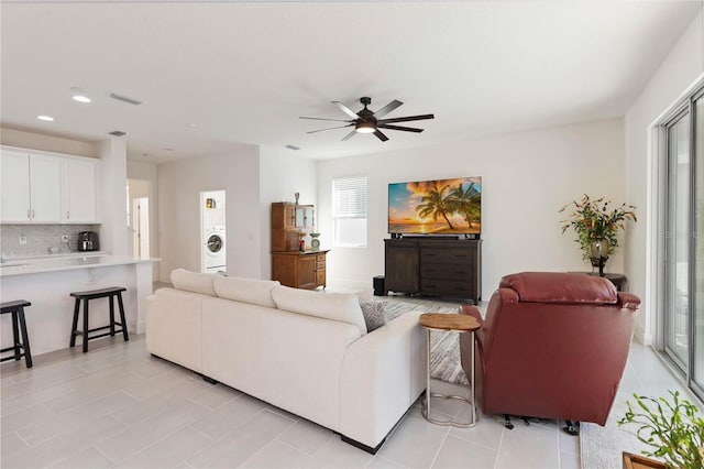 living room with washer / dryer, ceiling fan, visible vents, and recessed lighting