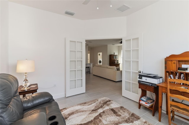 tiled office featuring visible vents, a ceiling fan, and french doors