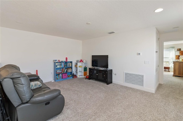 interior space with visible vents, a textured ceiling, and baseboards