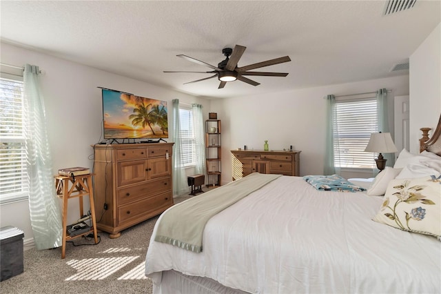 bedroom featuring visible vents, carpet flooring, and multiple windows