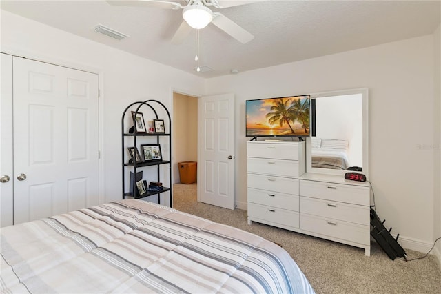 bedroom with light carpet, baseboards, visible vents, and a ceiling fan