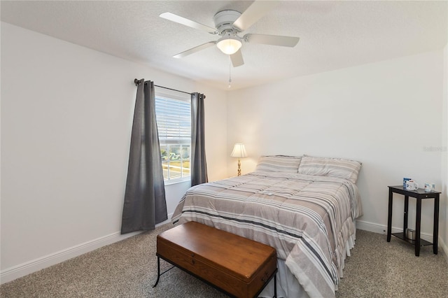 carpeted bedroom featuring a textured ceiling, a ceiling fan, and baseboards