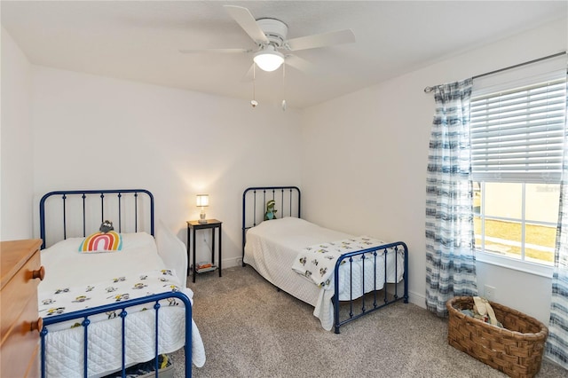 carpeted bedroom featuring ceiling fan and baseboards