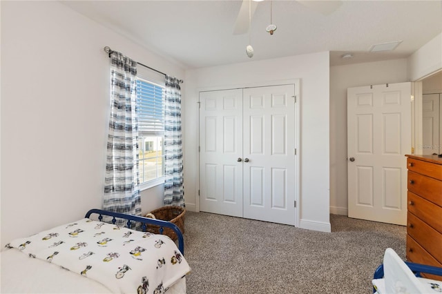 bedroom with carpet floors, a closet, baseboards, and a ceiling fan