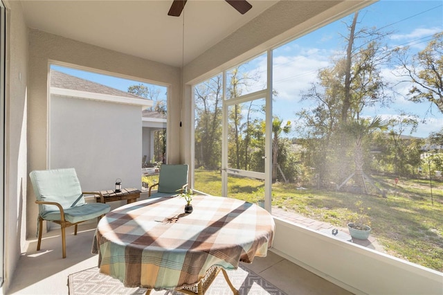 sunroom with a wealth of natural light and a ceiling fan