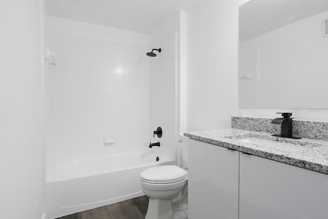 bathroom featuring visible vents, toilet, wood finished floors, vanity, and shower / bathing tub combination