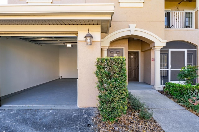 property entrance featuring a garage and stucco siding