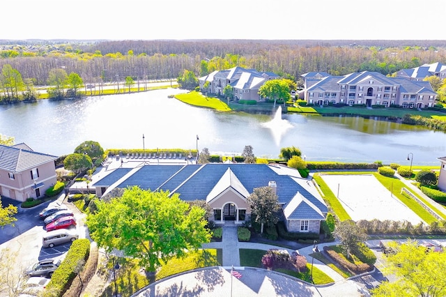 birds eye view of property featuring a water view, a residential view, and a view of trees