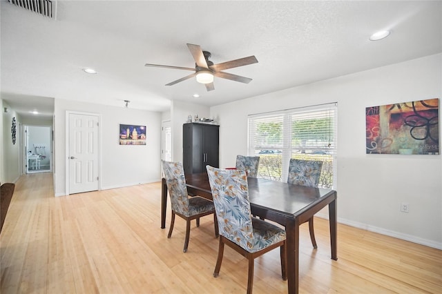 dining space featuring light wood-type flooring, baseboards, and visible vents