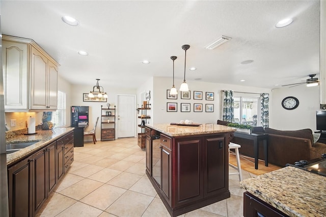 kitchen with recessed lighting, visible vents, a kitchen breakfast bar, and pendant lighting