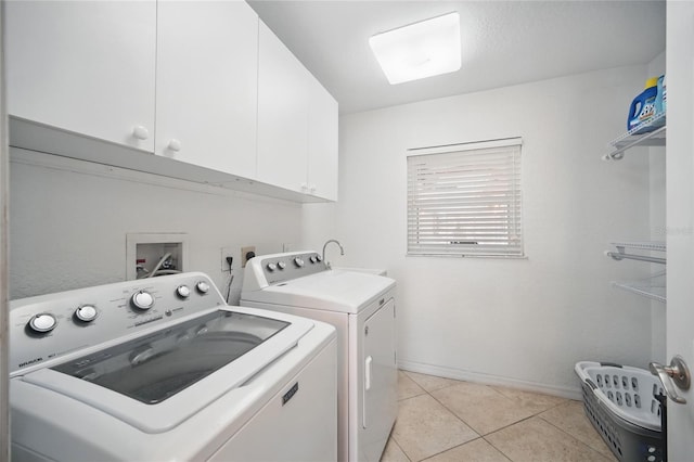 clothes washing area featuring cabinet space, independent washer and dryer, baseboards, and light tile patterned floors