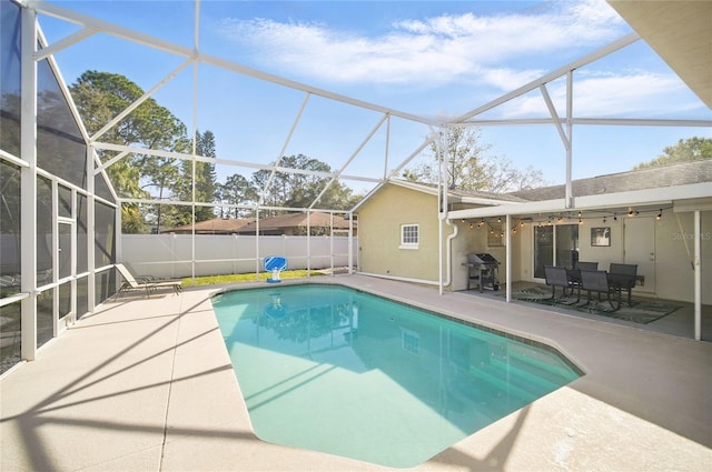 view of pool with a fenced in pool, a patio, grilling area, fence, and a lanai