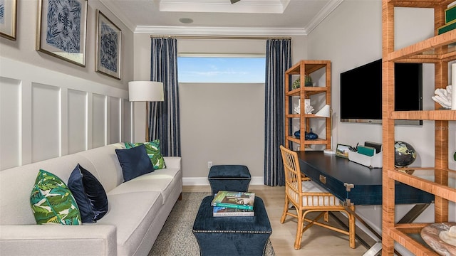 living room featuring ornamental molding, baseboards, and wood finished floors