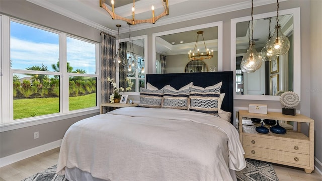 bedroom with a notable chandelier, wood finished floors, baseboards, ornamental molding, and a raised ceiling