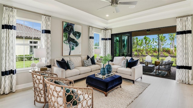 living area featuring crown molding, ceiling fan, and wood finished floors