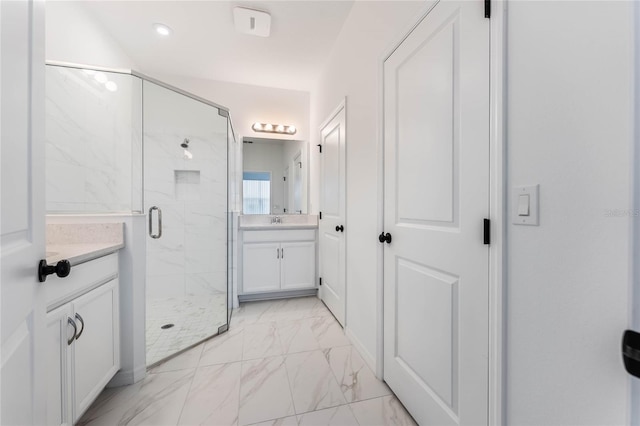 full bathroom featuring a stall shower, marble finish floor, and vanity