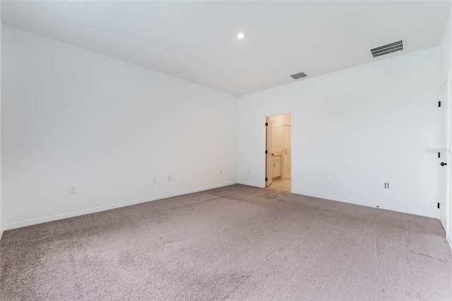 unfurnished room featuring light carpet, visible vents, and baseboards