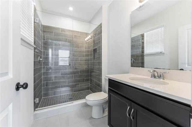 bathroom featuring a stall shower, vanity, toilet, and tile patterned floors