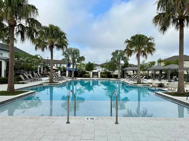 community pool with a patio area and a gazebo