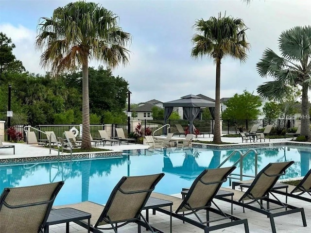 pool with fence and a patio