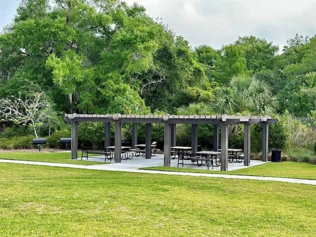 view of home's community with a yard and a pergola