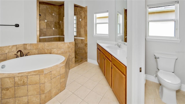 full bathroom with vanity, a garden tub, plenty of natural light, and tile patterned flooring