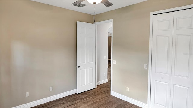 unfurnished bedroom with visible vents, ceiling fan, baseboards, wood finished floors, and a closet