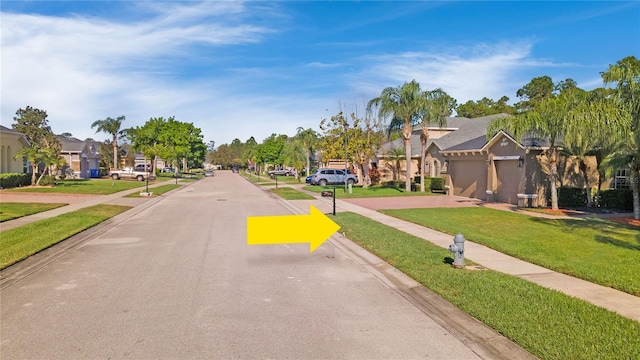 view of road with a residential view, curbs, and sidewalks