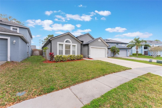 ranch-style home featuring driveway, an attached garage, a front lawn, and stucco siding