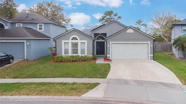 ranch-style house featuring a garage, driveway, a front lawn, and stucco siding