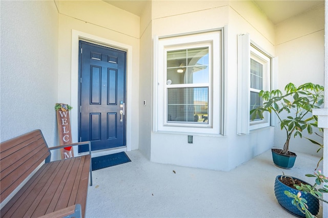 entrance to property featuring stucco siding