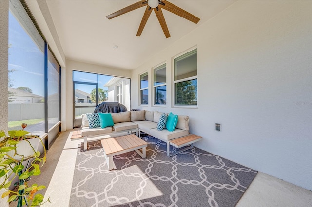 sunroom featuring ceiling fan