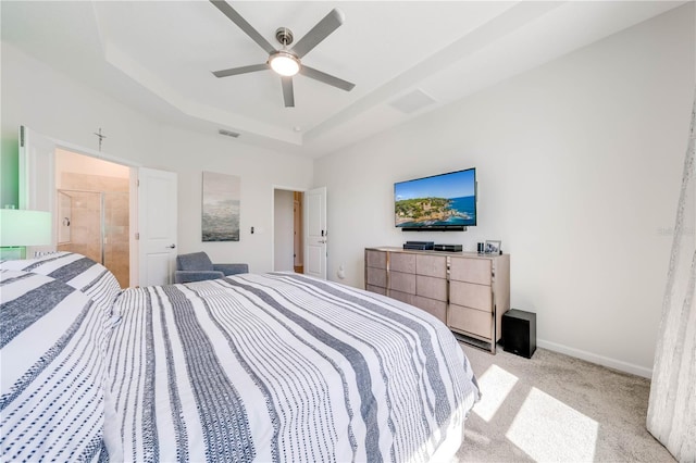 bedroom with visible vents, a tray ceiling, baseboards, and light colored carpet