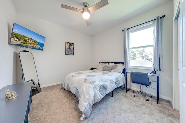 bedroom featuring a ceiling fan, light carpet, and baseboards