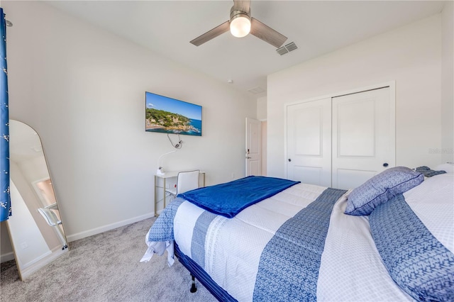 bedroom featuring a closet, visible vents, a ceiling fan, carpet flooring, and baseboards