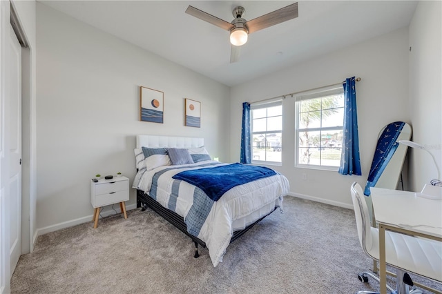 bedroom with carpet flooring, a ceiling fan, and baseboards