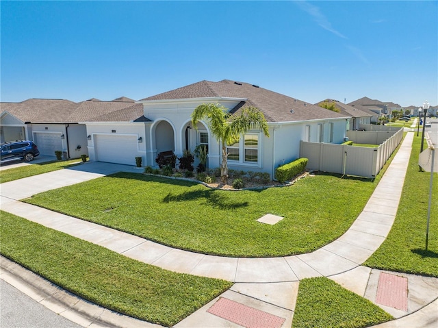 mediterranean / spanish-style house featuring stucco siding, an attached garage, a gate, driveway, and a front lawn