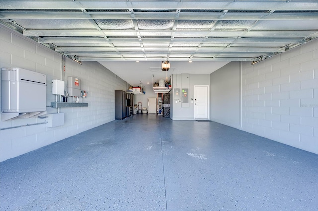 garage featuring concrete block wall and a garage door opener