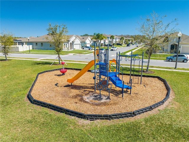 community jungle gym featuring a residential view and a yard